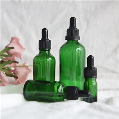 Зелені скляні пляшки-крапельниці